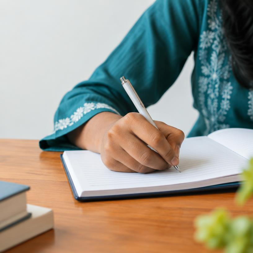 Student taking notes while learning